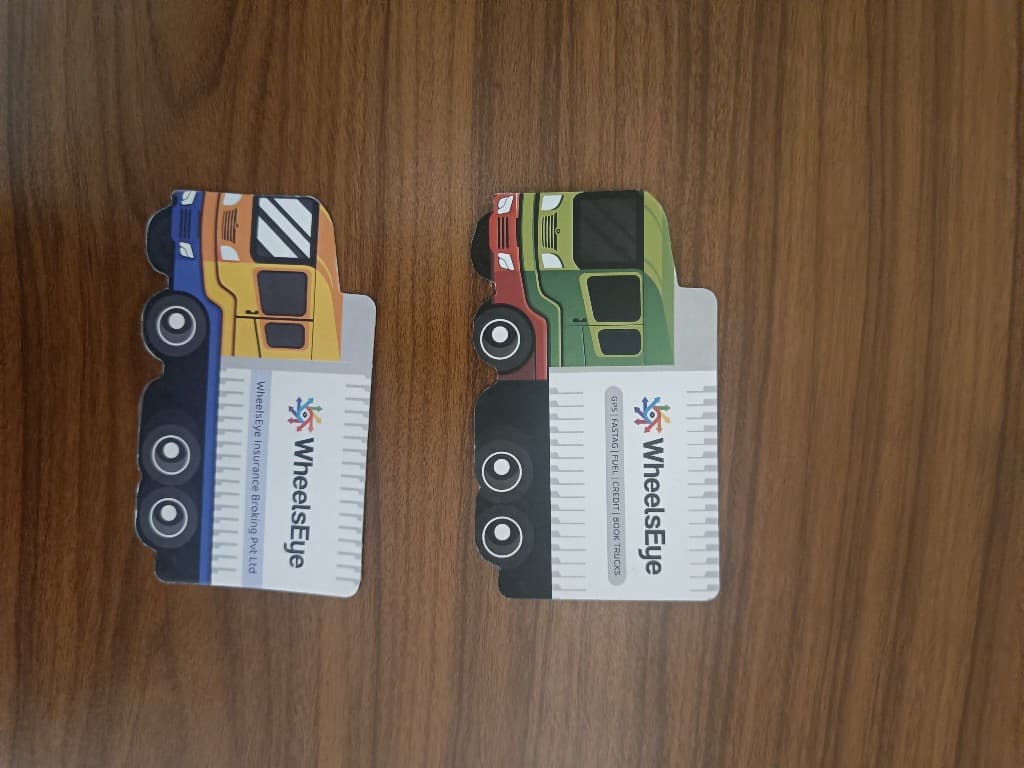 Two WheelsEye truck card variants side by side showing insurance broking and services versions