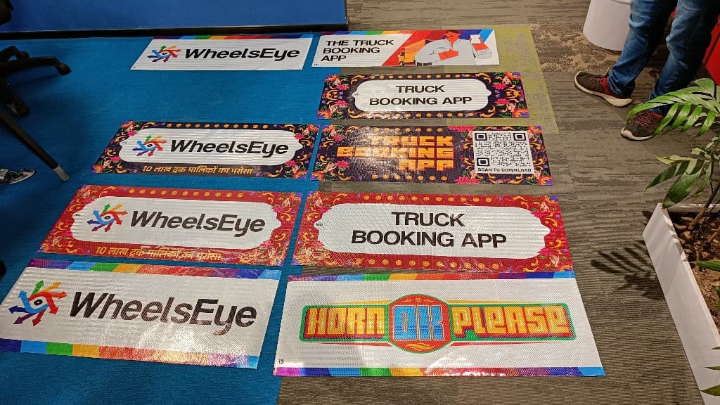Eight WheelsEye sticker design variants including truck art, QR codes, and Horn OK Please styles