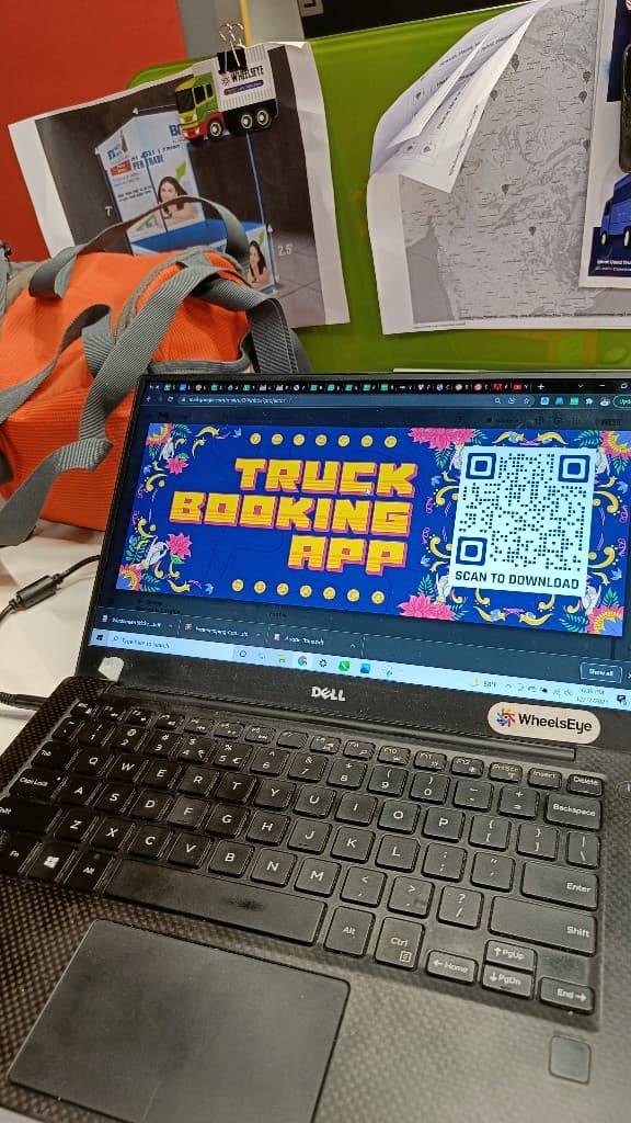 WheelsEye truck booking app sticker design on a laptop in the office